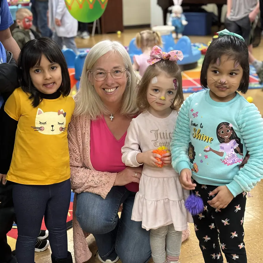 Calvary Nursery School children celebrating with their teacher